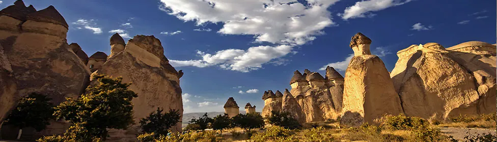 Cappadocia fairy chimneys illuminated beneath a deep blue sky