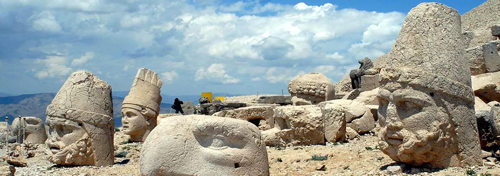 Monumental stone figures at Mount Nemrut in warm light